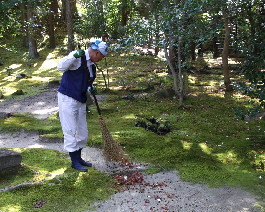 Isuien Garden - the gardener is kept busy sweeping the fallen leaves and dropping left by the local fauna